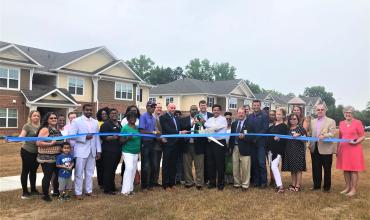 Group of people cutting a ribbon