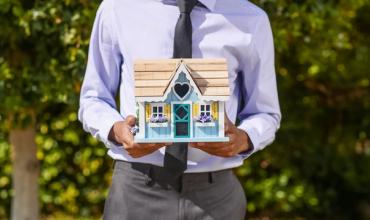 graphic of man holding a house