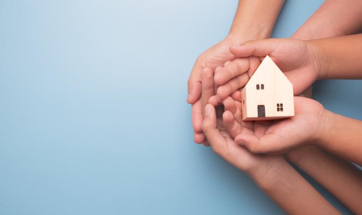 Hands holding a house 