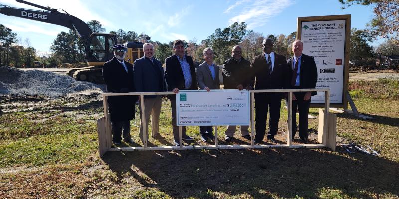 Photo of a group holding up a check