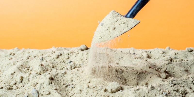 Groundbreaking Event for Abbott Crossing on September 11 in Goldsboro Shovel picking up dirt with a yellow background