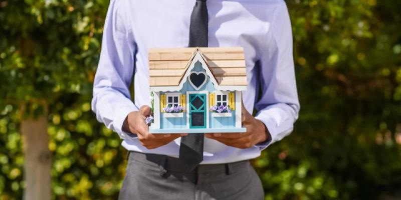 graphic of man holding a house