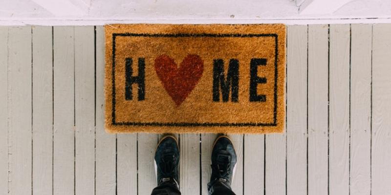 A front door mat that says "Home" with a heart for the "O"