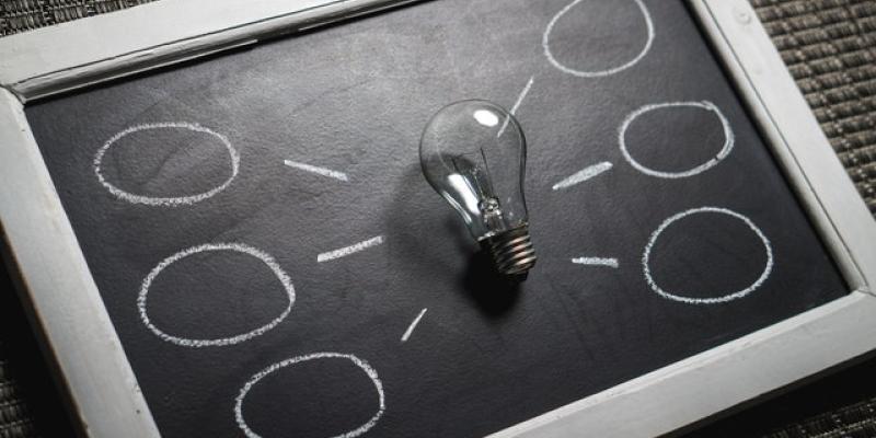 Lightbulb laying on a chalkboard