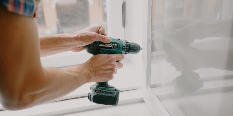 Man using power tool on door