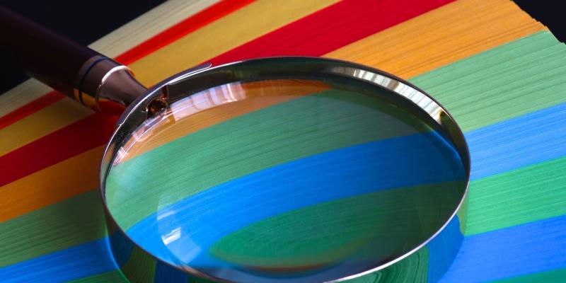 Magnifying glass over colored paper